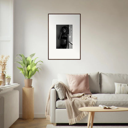 Framed black and white photograph of a person hanging on a wall.