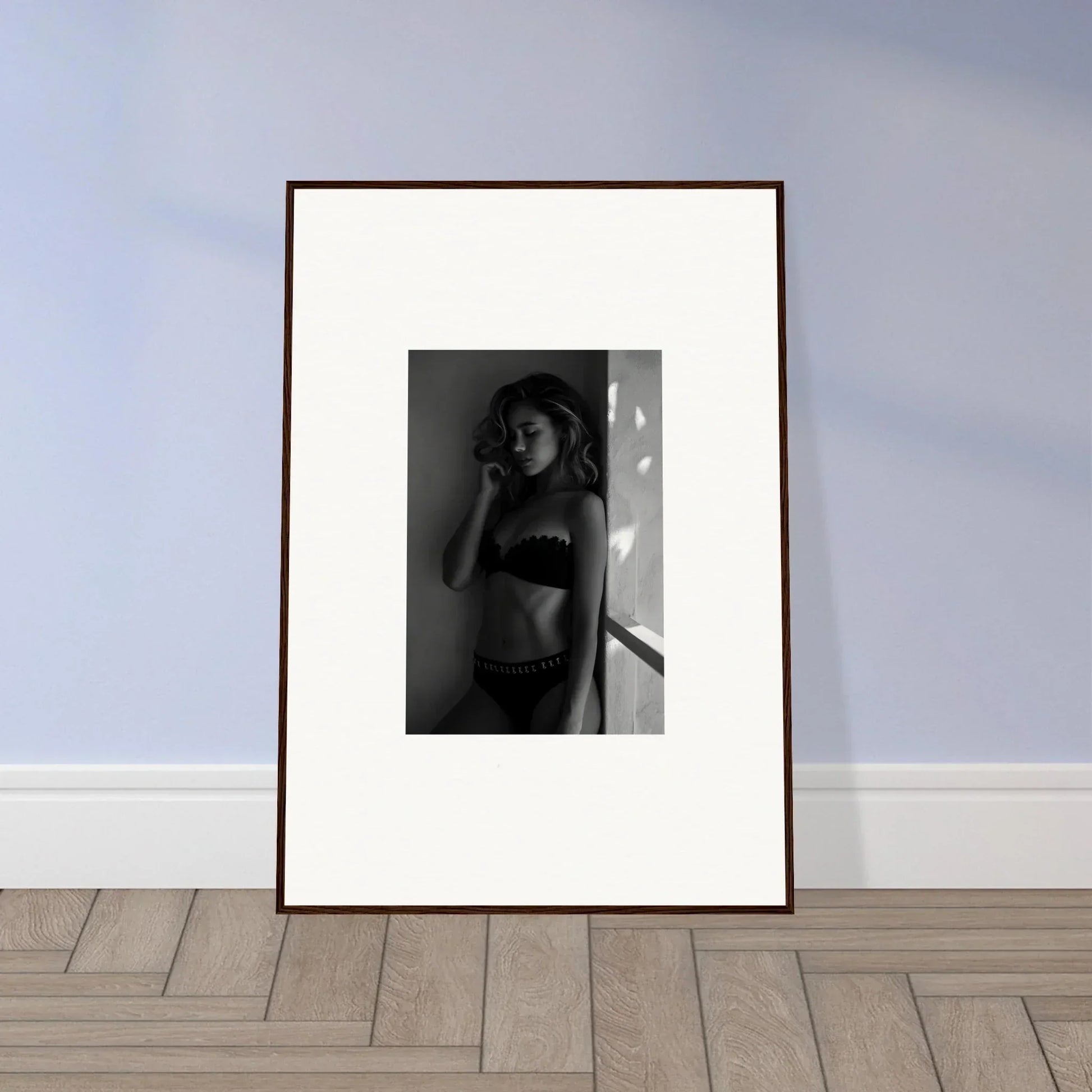 Framed black and white photograph of a woman in underwear.