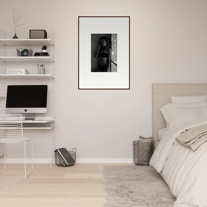 Minimalist bedroom with white walls, floating shelves, and a framed black and white photograph.