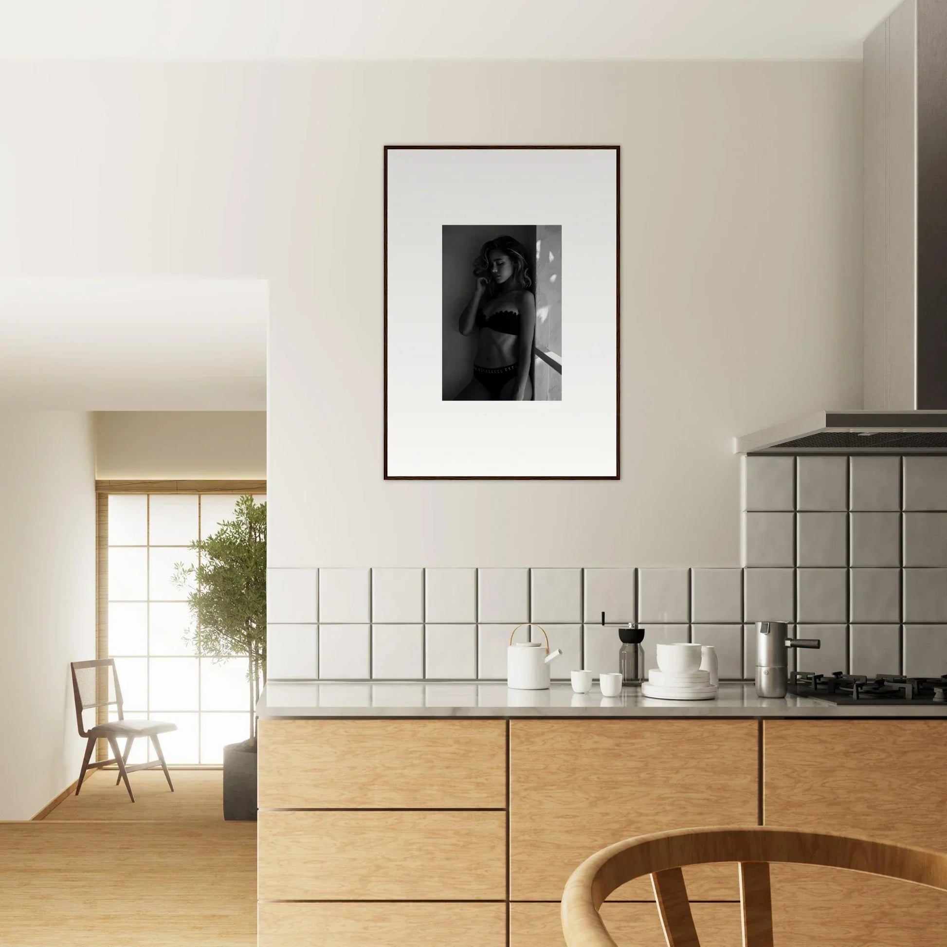 Modern kitchen with wooden cabinetry and a framed black-and-white photograph on the wall.