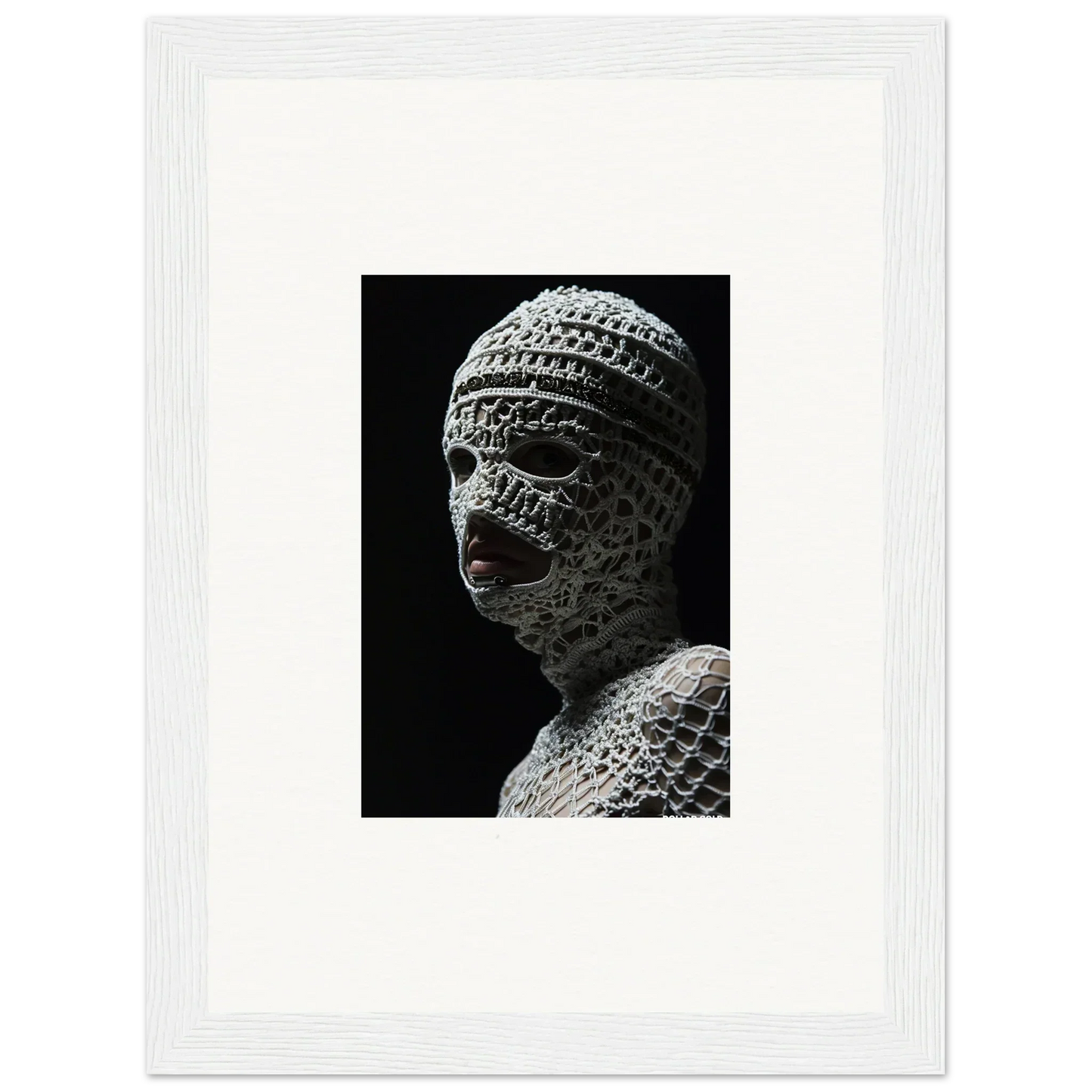 Sculpture of a head wrapped in bandages or textured material, with visible facial features.