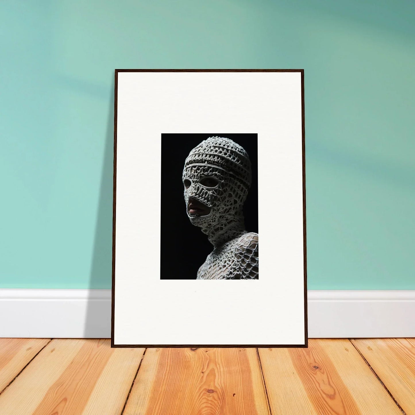 Framed black and white photograph of an ancient stone bust wearing a textured cap.