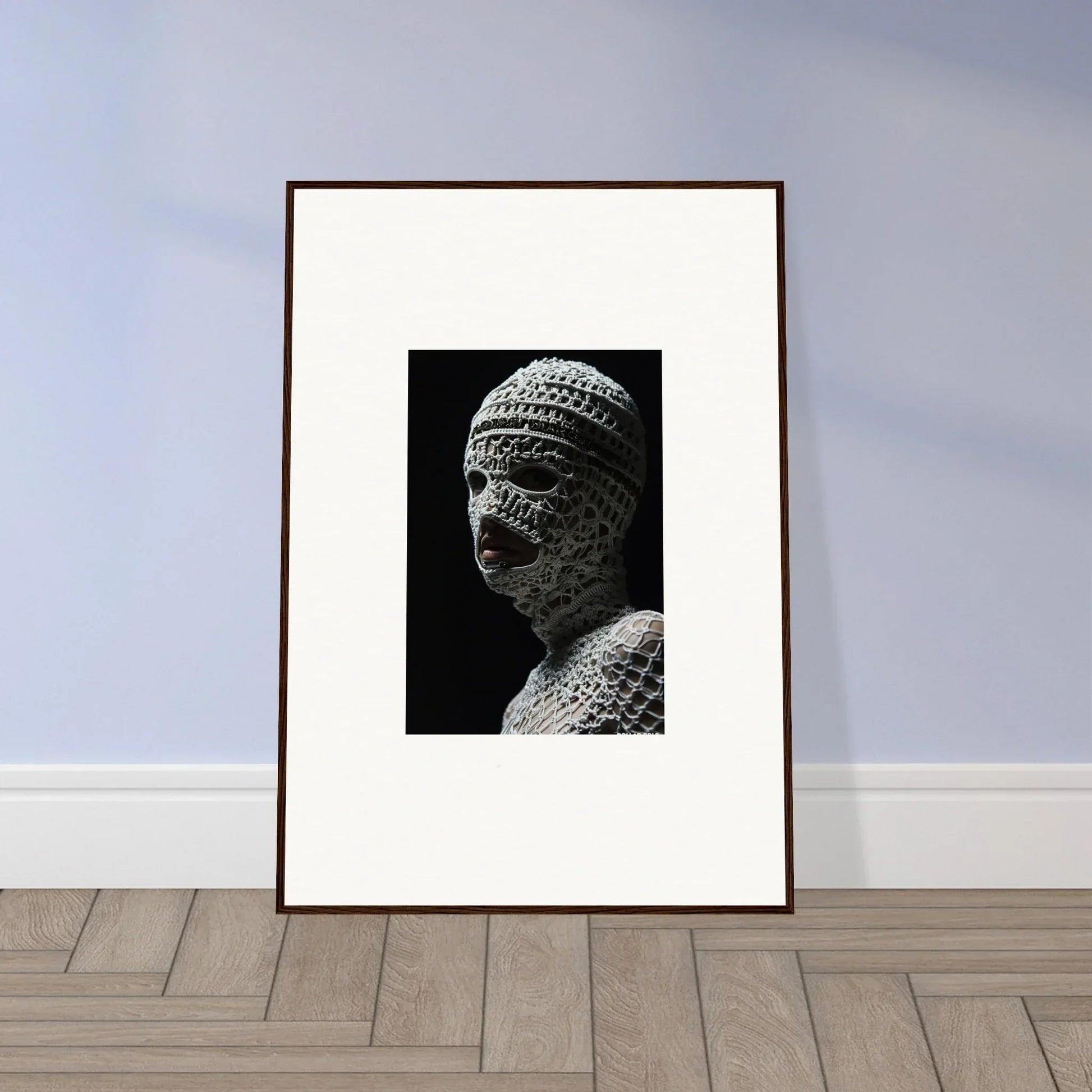 Framed black and white photograph of a sculptural bust with textured surface.