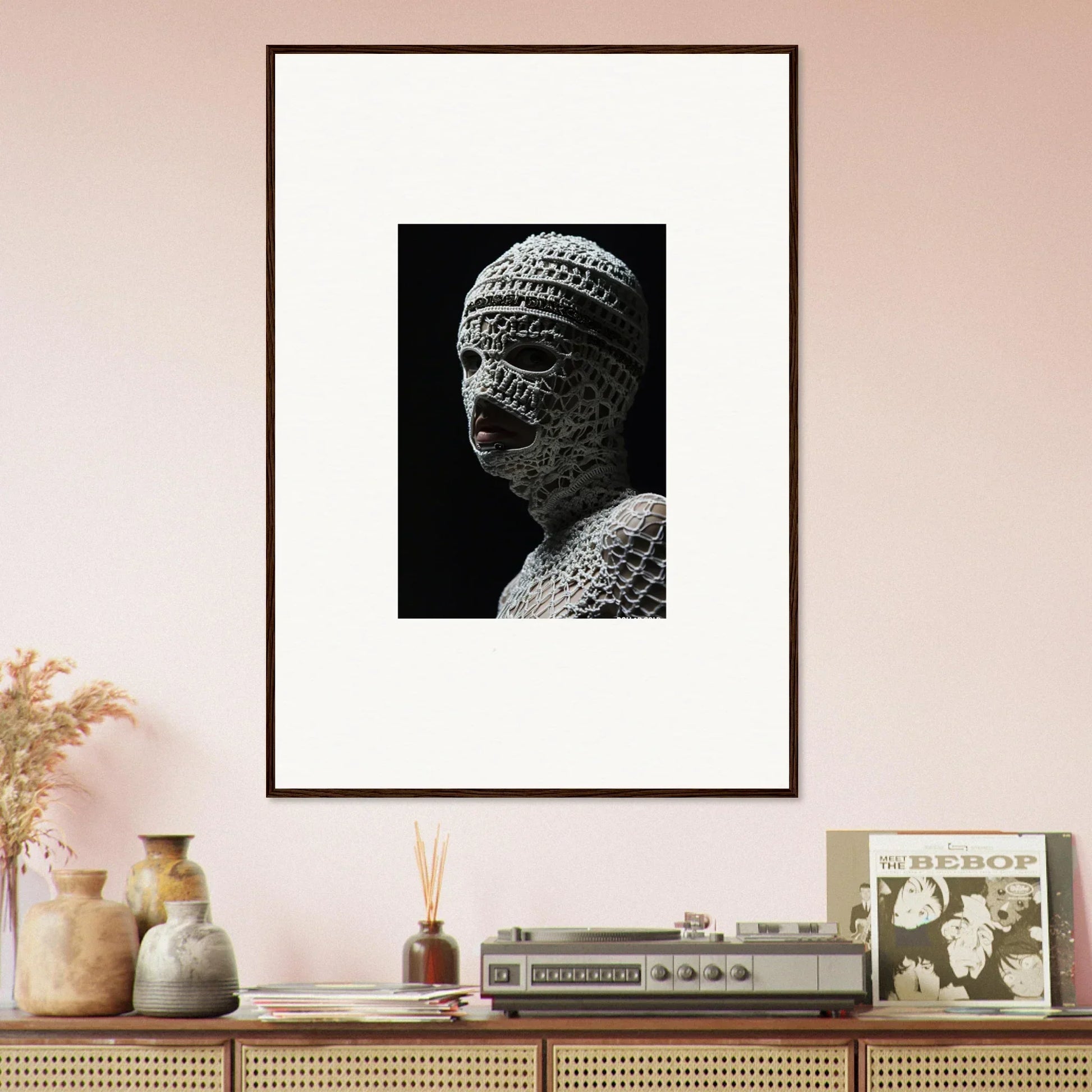 Framed black and white photograph of an ancient stone Buddha statue’s head and shoulders.