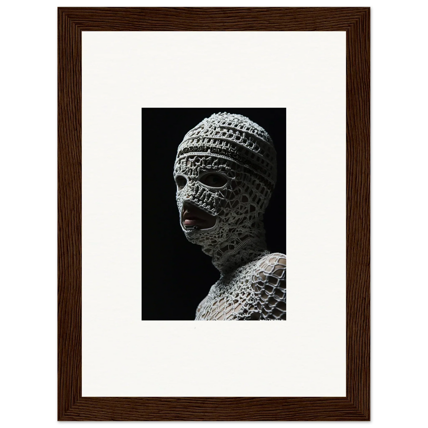 Sculpture of a head wrapped in bandages or cloth strips.