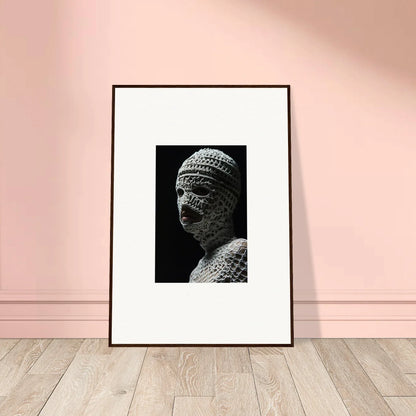 Framed black and white photograph of an ancient sculptural bust with intricate textures.