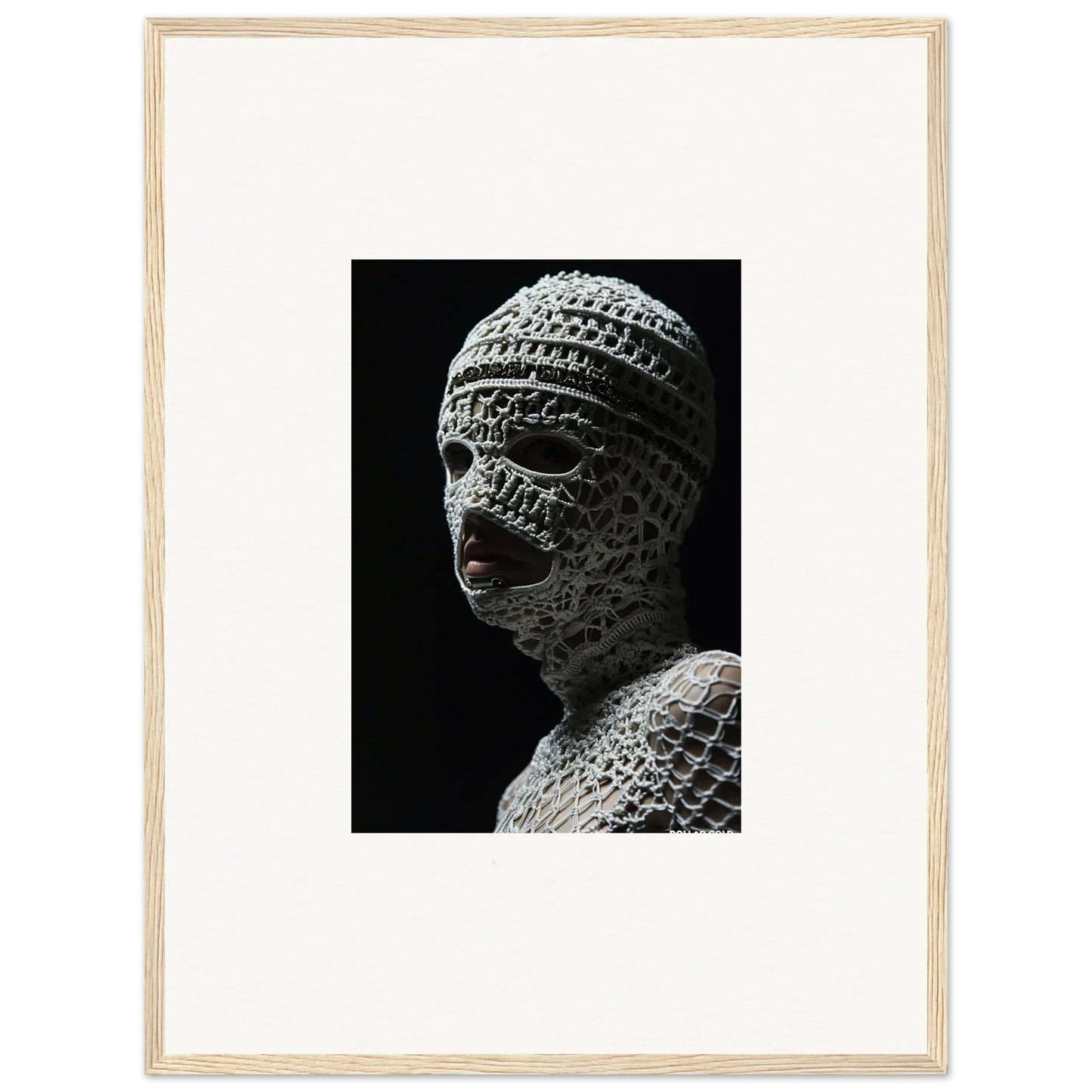 Sculpture of a head covered in intricate bandage-like wrappings.