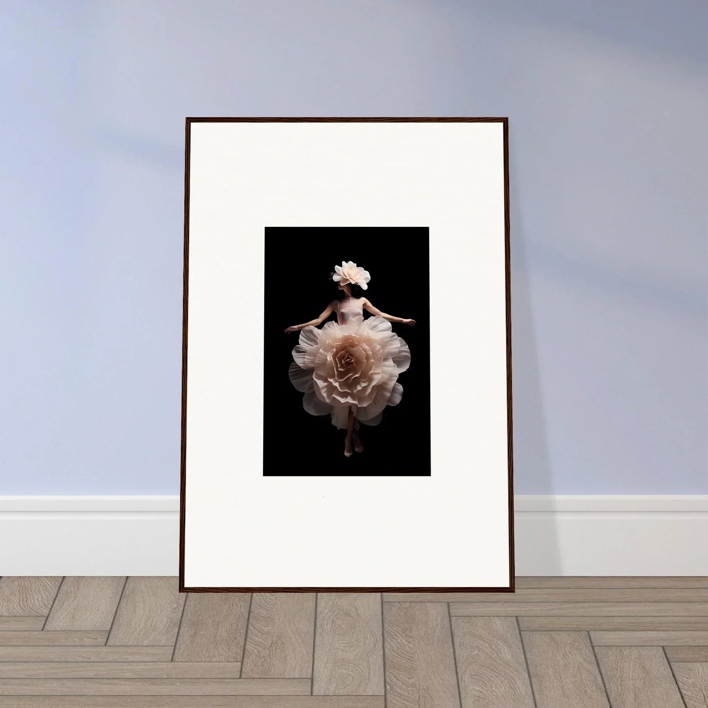 Framed artwork featuring a pale rose bloom against a dark background.