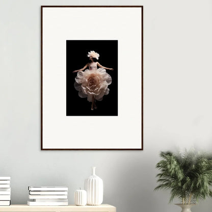 Framed artwork depicting a figure emerging from or transforming into a large, pale flower against a dark background.