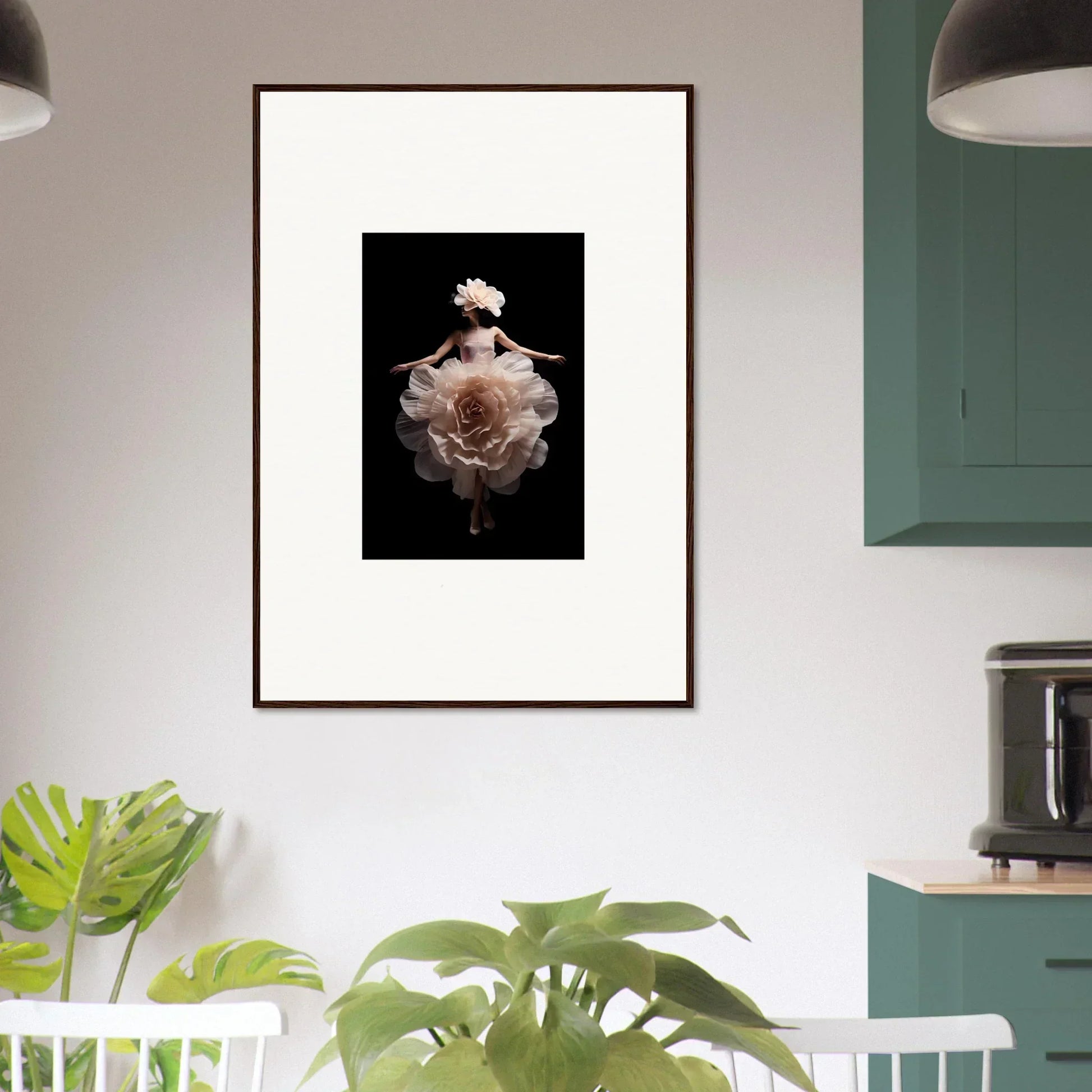 Framed artwork featuring a delicate rose bloom against a dark background.