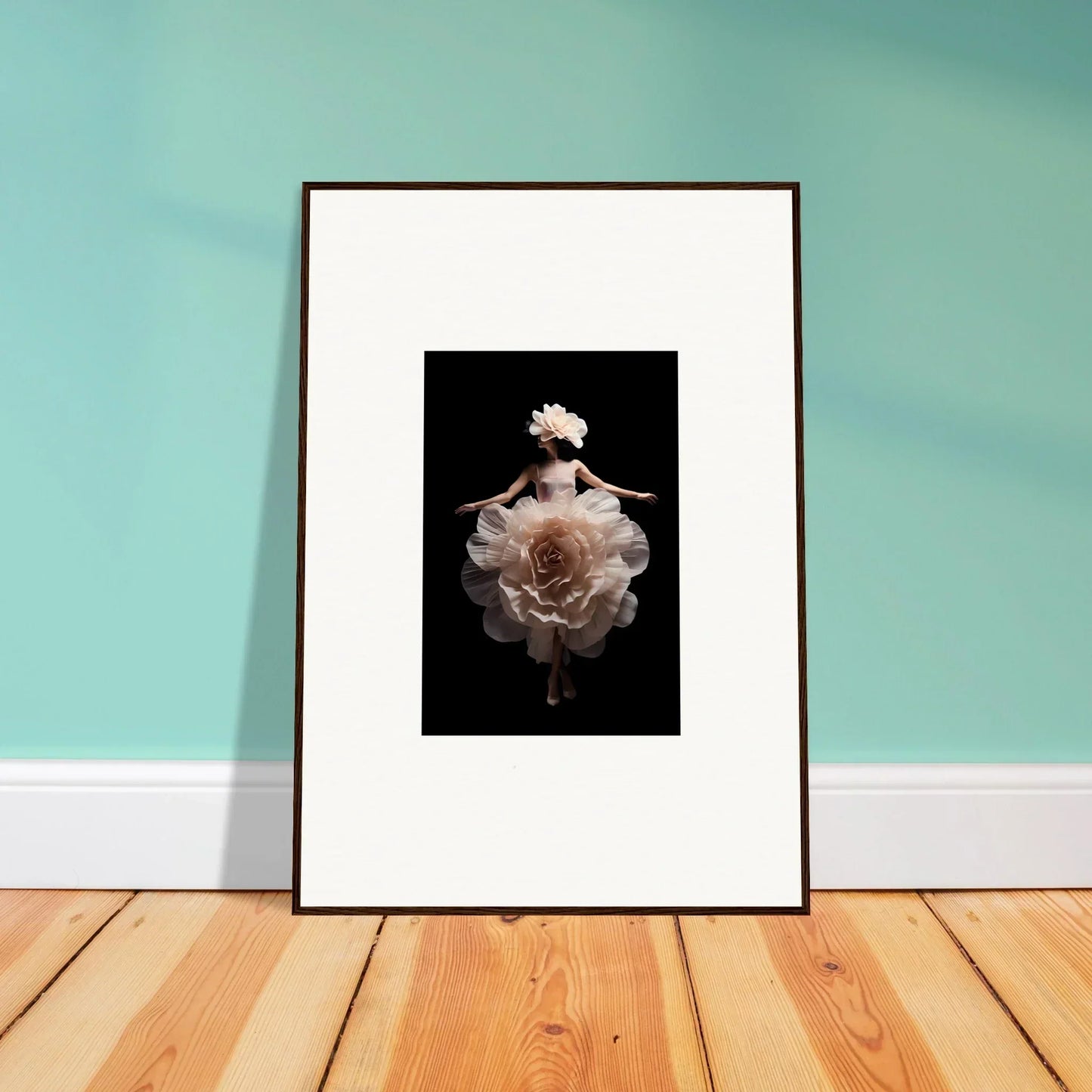 Framed artwork featuring a figure emerging from or blending with a pale flower against a dark background.