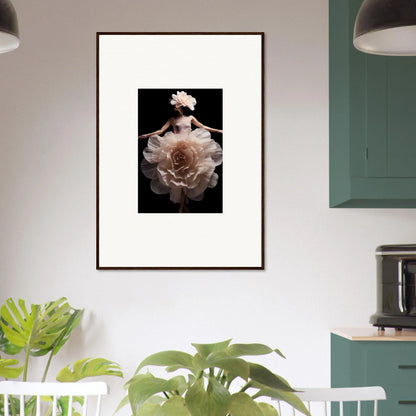 Framed artwork depicting a figure emerging from or surrounded by a large, pale flower against a dark background.