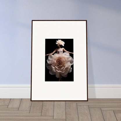 Framed artwork featuring a delicate white flower against a dark background.