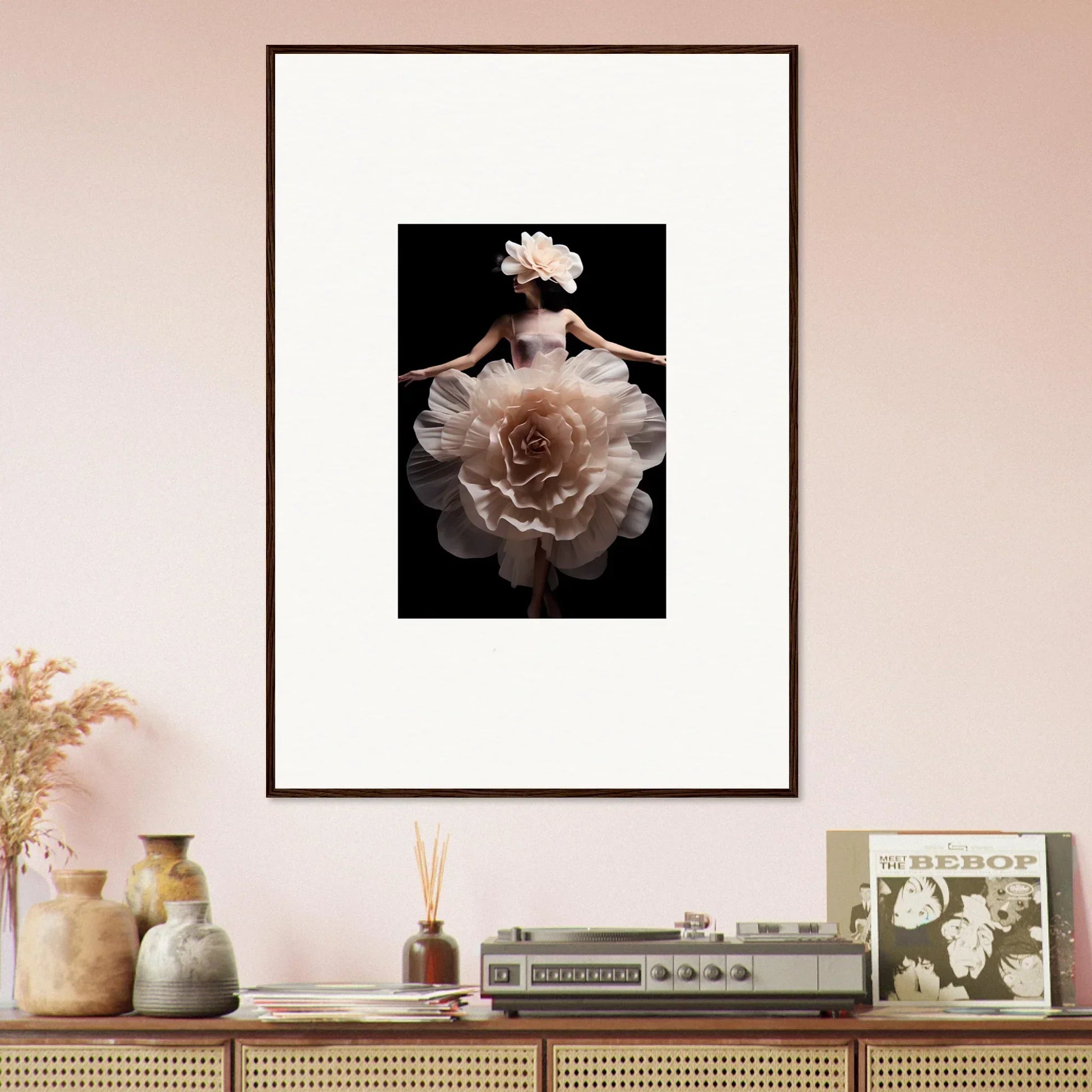 Framed artwork depicting a figure emerging from or merging with a white flower against a dark background.