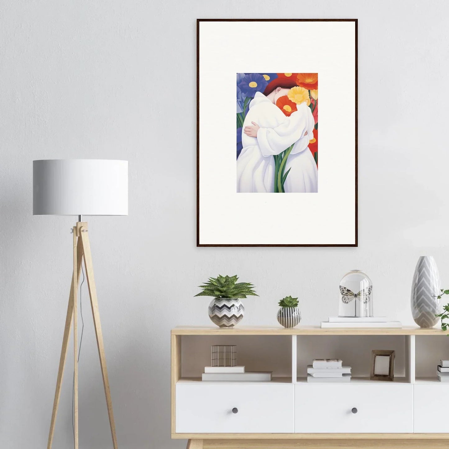 Framed abstract painting of figures in white with colorful floral elements for room decor