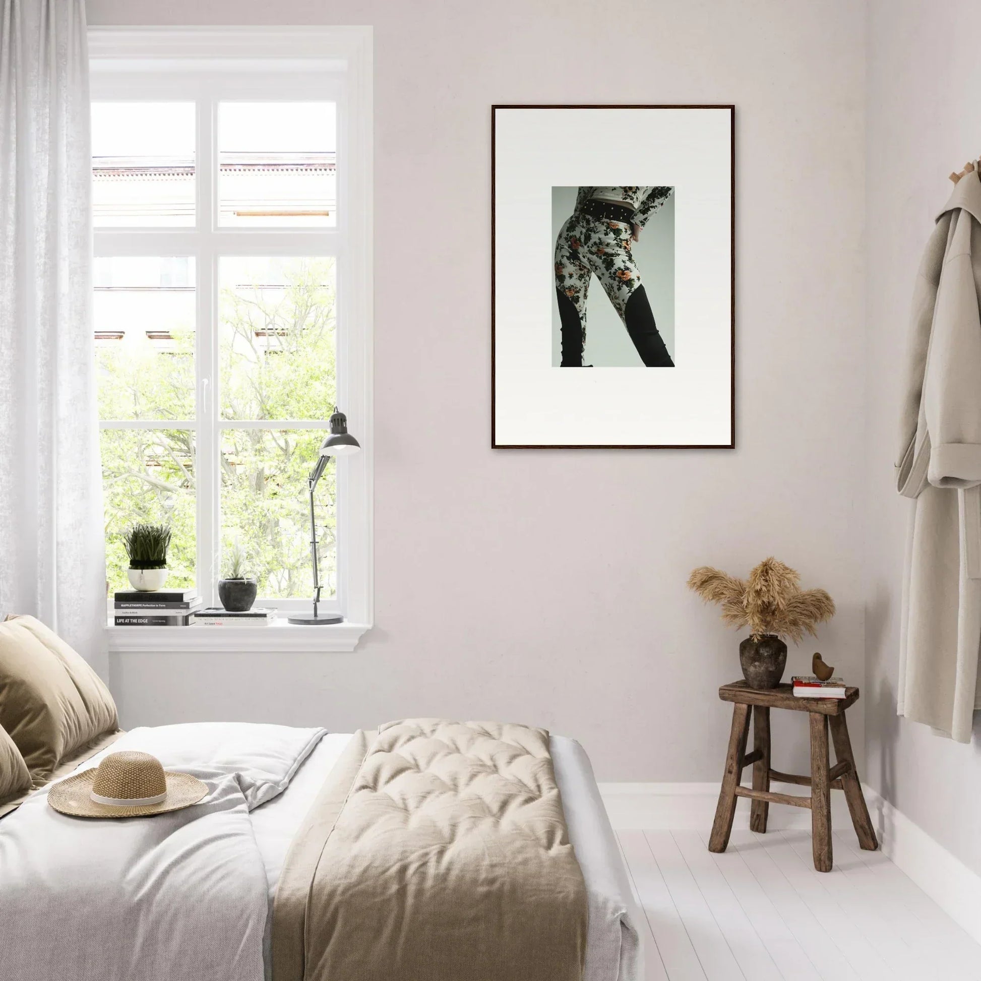 Cozy bedroom with neutral decor and a framed cat photograph on the wall.