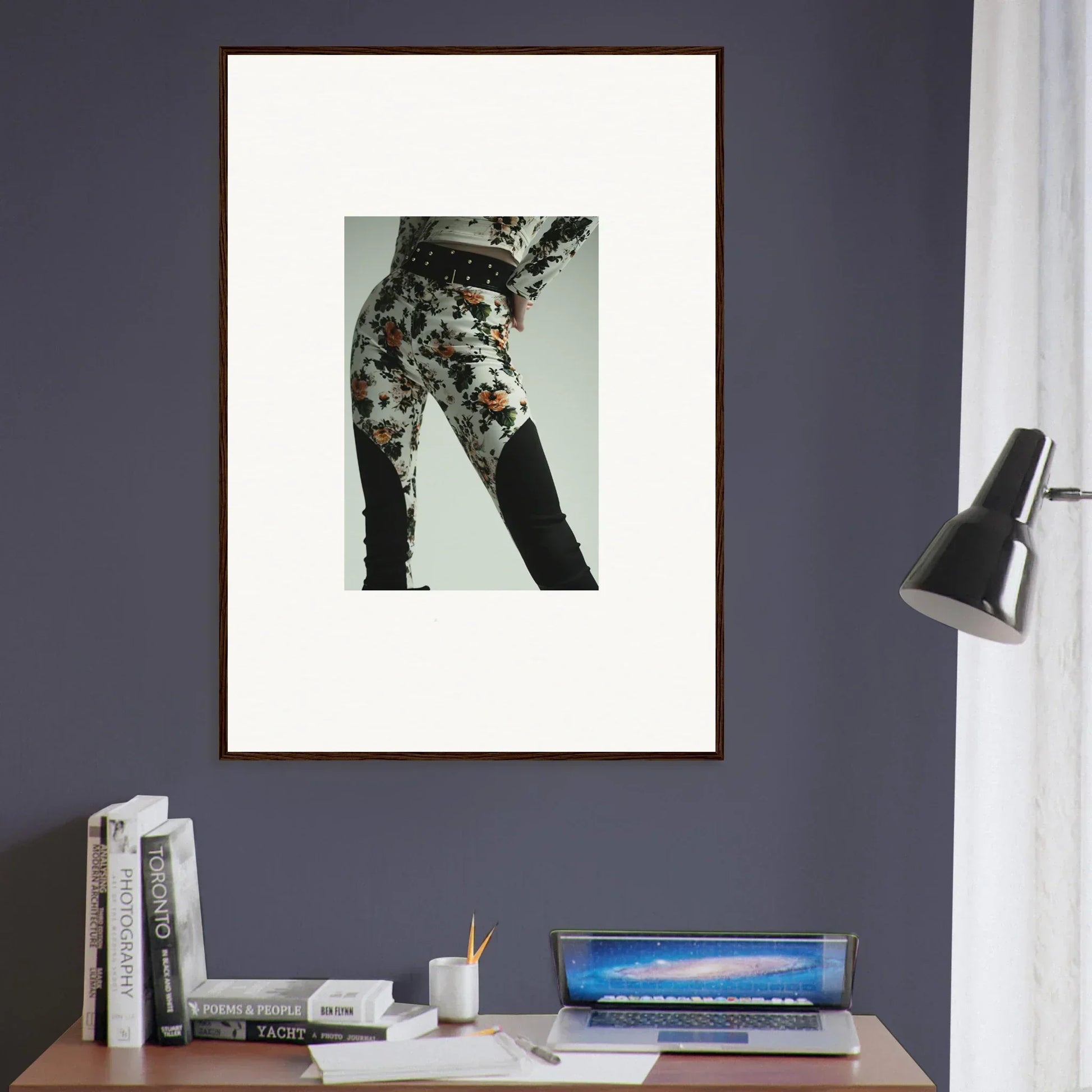 Framed artwork depicting a person’s lower body wearing patterned pants.