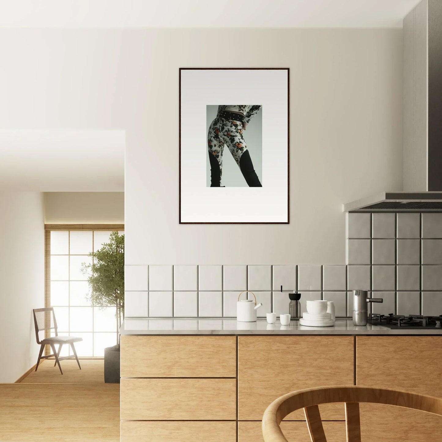 Modern kitchen with wooden cabinetry and a framed black-and-white artwork on the wall.