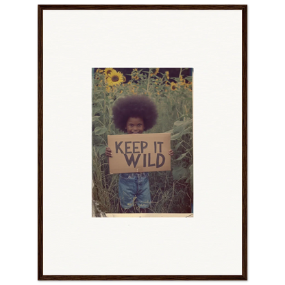 Framed photograph of someone with a KEEP IT WILD sign in sunflowers for room decoration