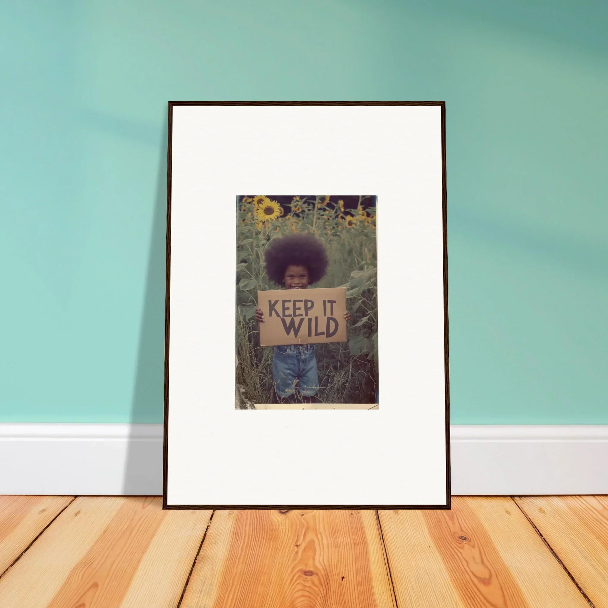 Framed photo of a person with a KEEP IT WILD sign, perfect for room decoration or canvas print