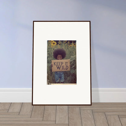 Framed canvas print of person with KEEP IT WILD sign in nature, perfect for room decoration