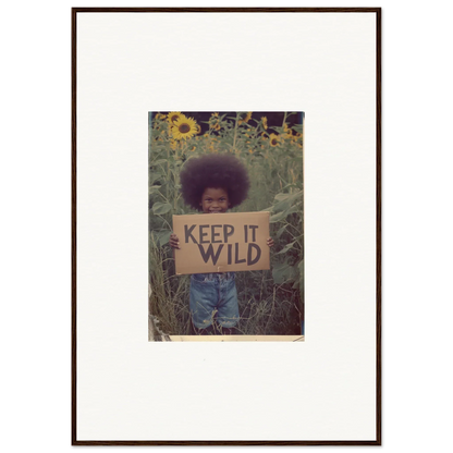 Framed photograph of a person with KEEP IT WILD sign in sunflowers for room decoration