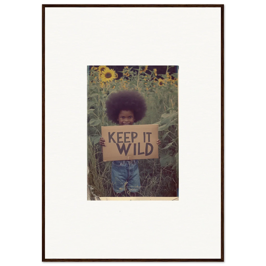 Framed photograph of a person with KEEP IT WILD sign in sunflowers for room decoration