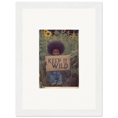 Framed photo of a person with an afro holding a KEEP IT WILD sign for room decoration