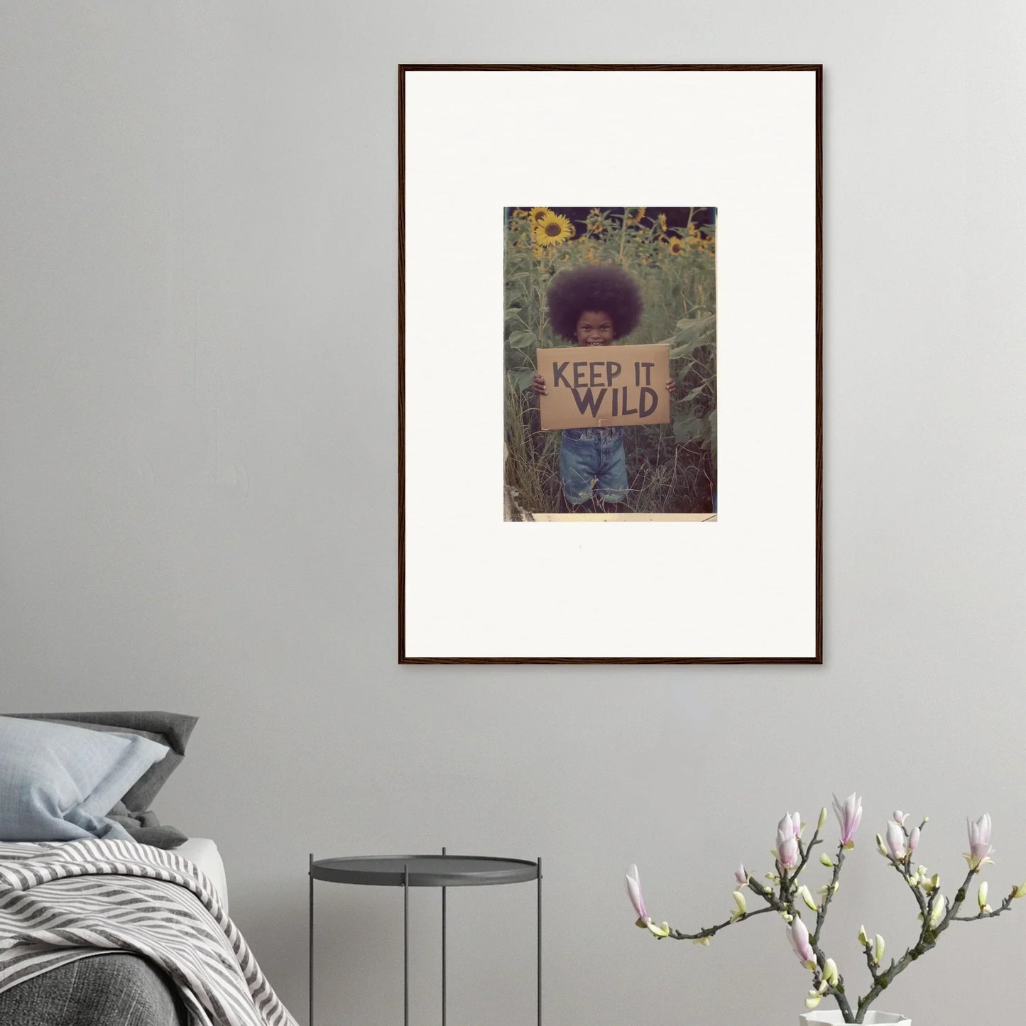 Framed canvas print of person holding KEEP IT WILD sign in nature for room decoration