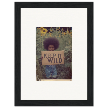 Framed canvas print of a person with an afro and a KEEP IT WILD sign in sunflowers