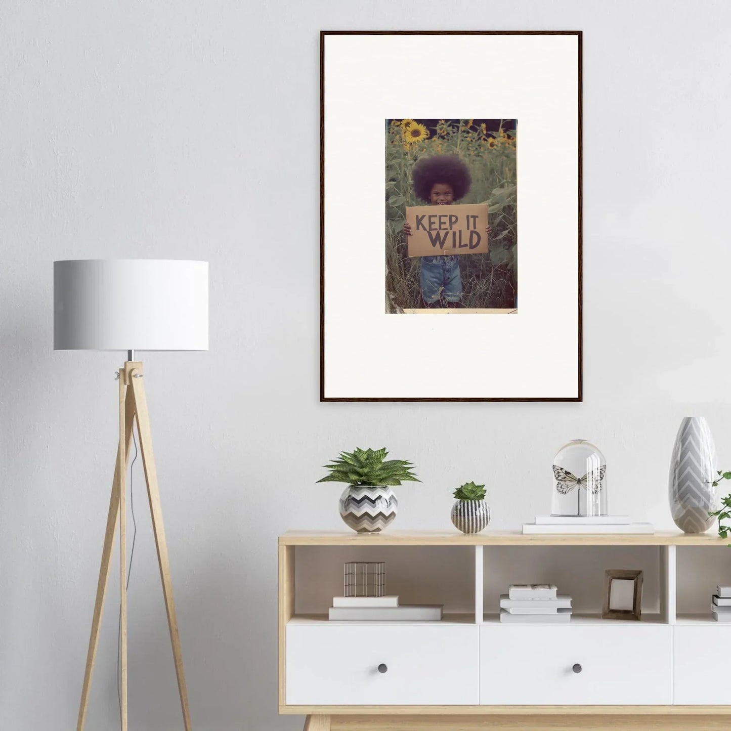 Framed canvas print of a person with a KEEP IT WILD sign in nature for room decoration