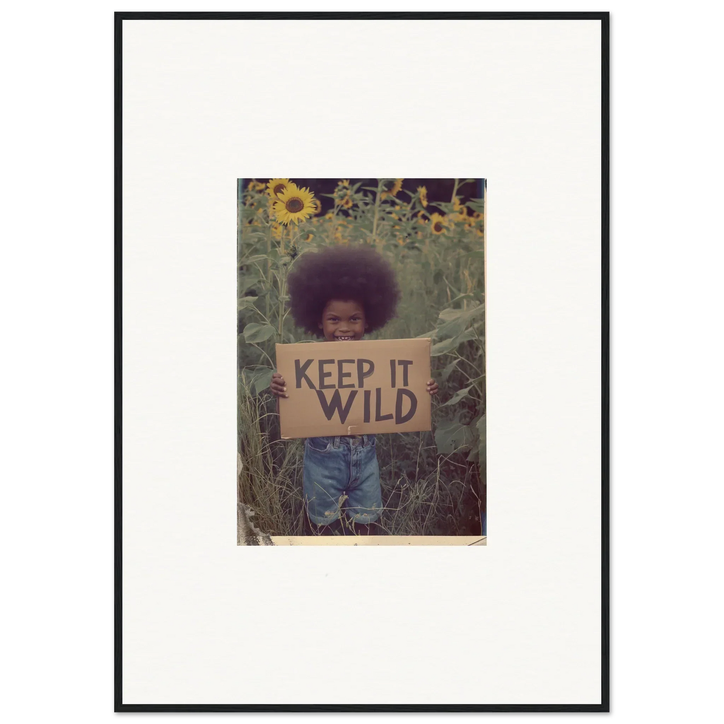 Framed photo of a person with a KEEP IT WILD sign, perfect for room decoration