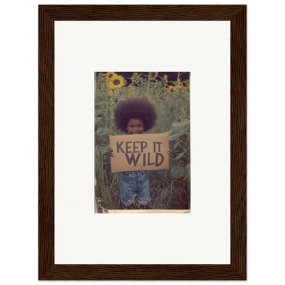 Person holding a KEEP IT WILD sign in a field of flowers for nature-inspired room decoration