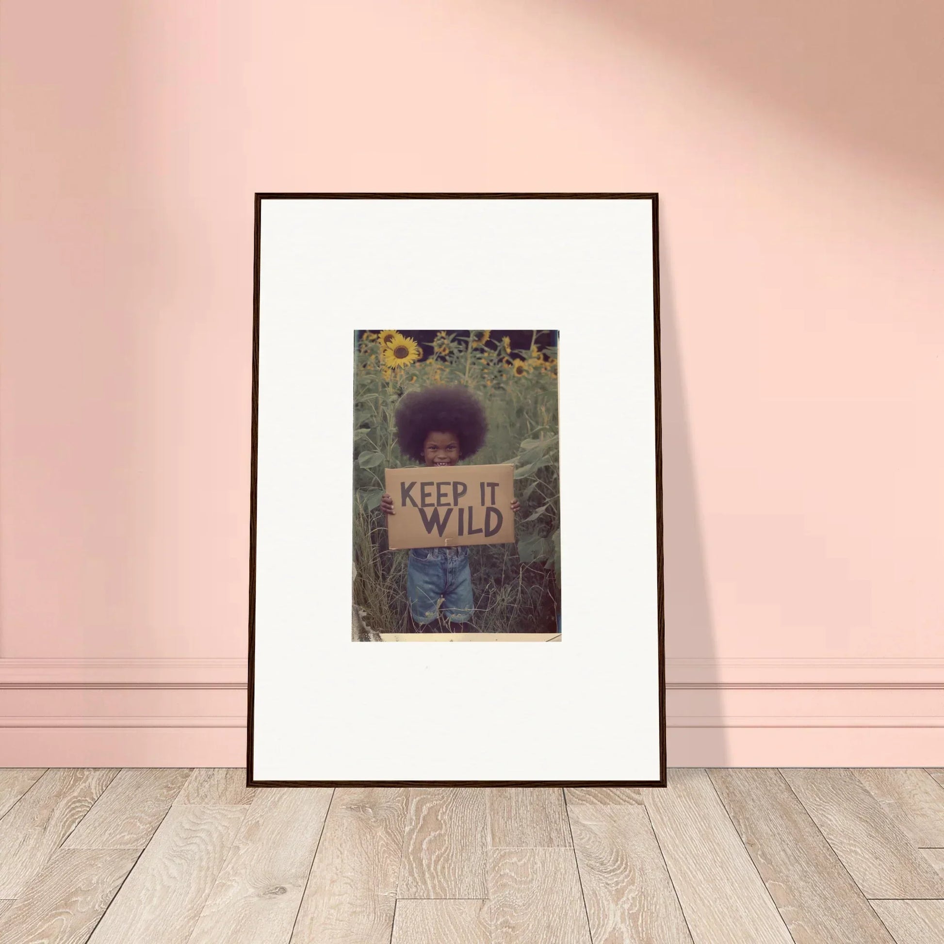 Framed canvas print of a person with a KEEP IT WILD sign in nature for room decoration