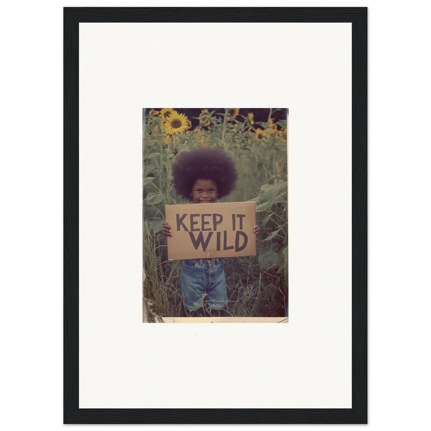 Framed canvas print of a person with KEEP IT WILD sign in sunflowers for room decoration