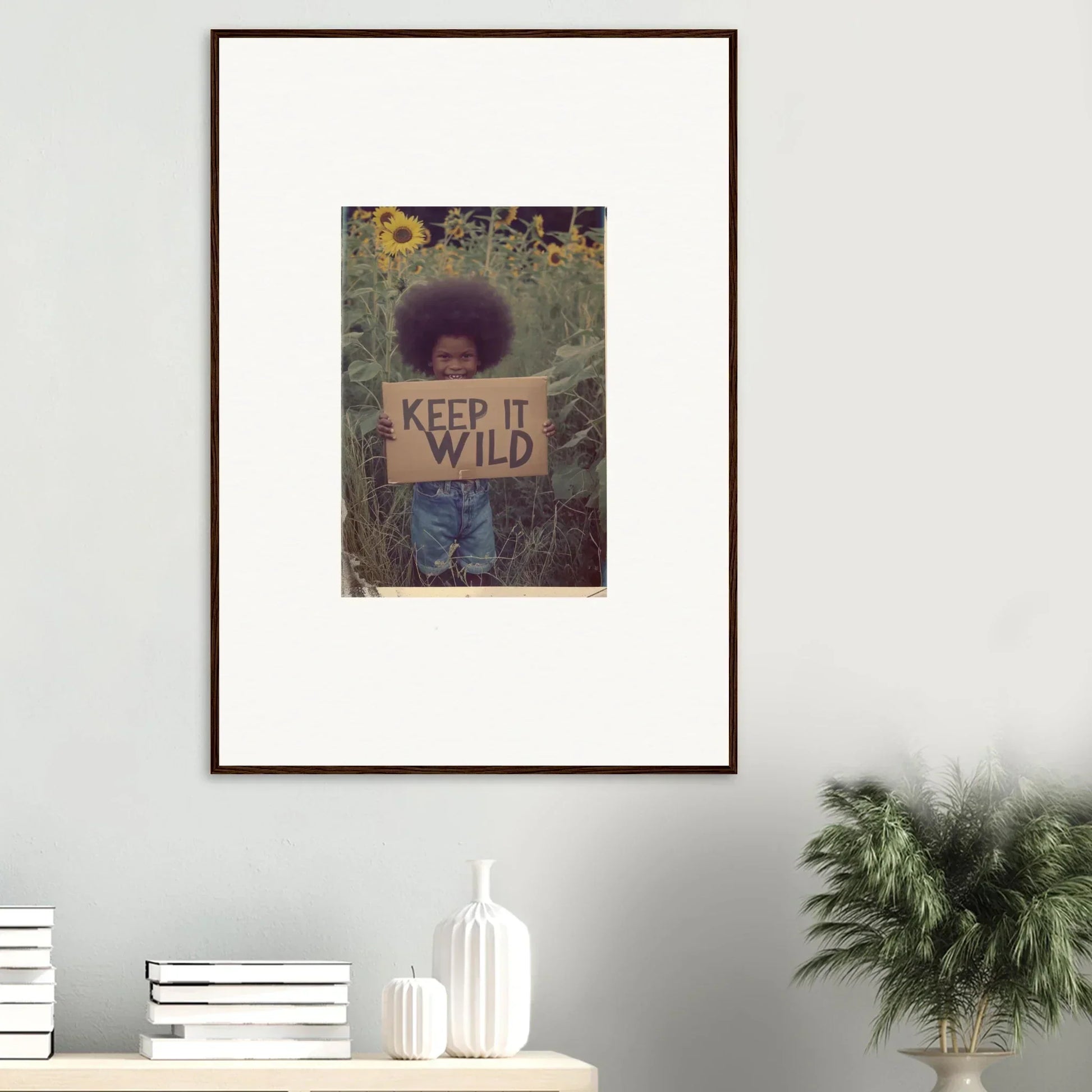 Framed canvas print showing a person with a KEEP IT WILD sign, perfect for room decoration