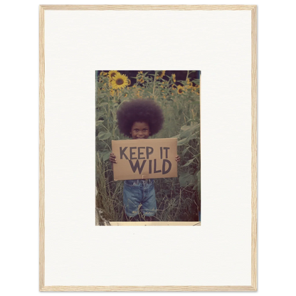 Framed photo of someone with a KEEP IT WILD sign in a sunflower field, perfect room decoration