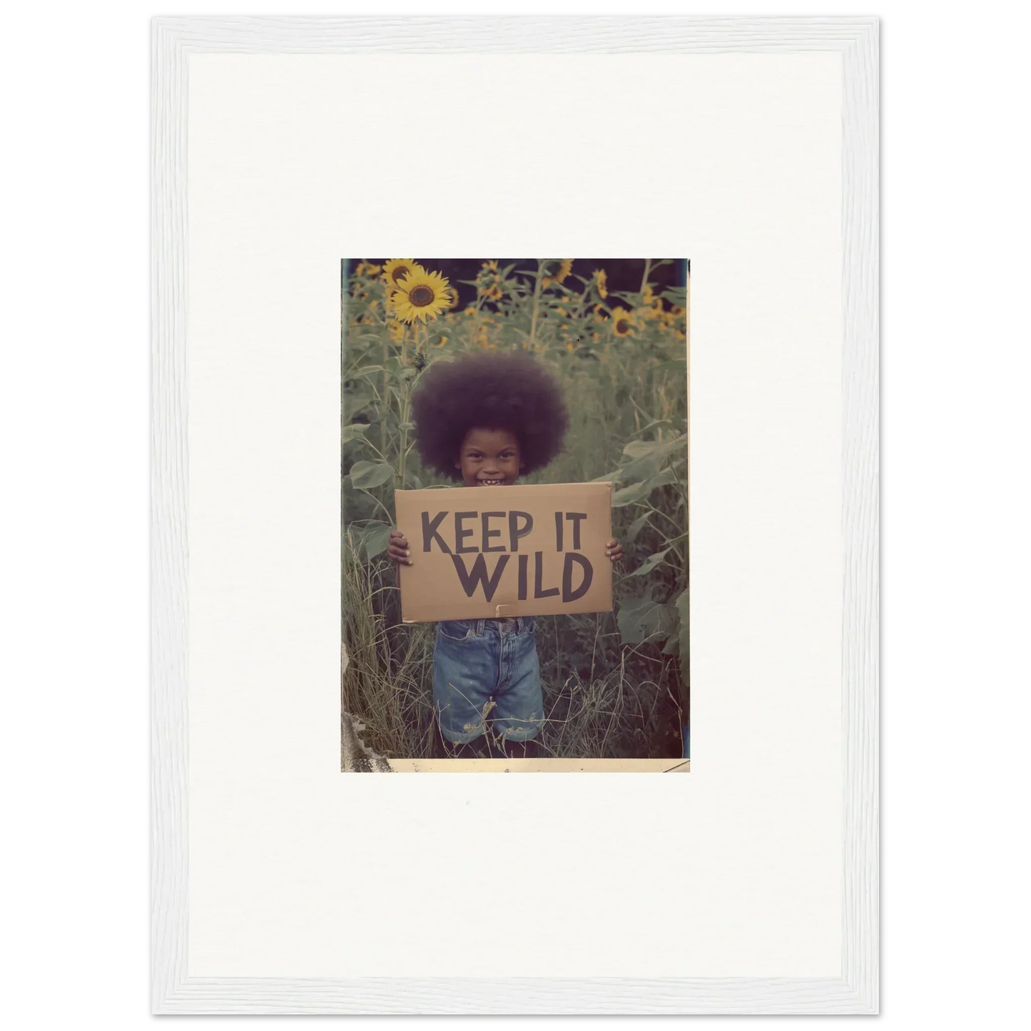 Framed canvas print of a person with a KEEP IT WILD sign in a sunflower garden