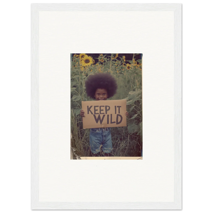 Framed canvas print of a person with a KEEP IT WILD sign in a sunflower garden