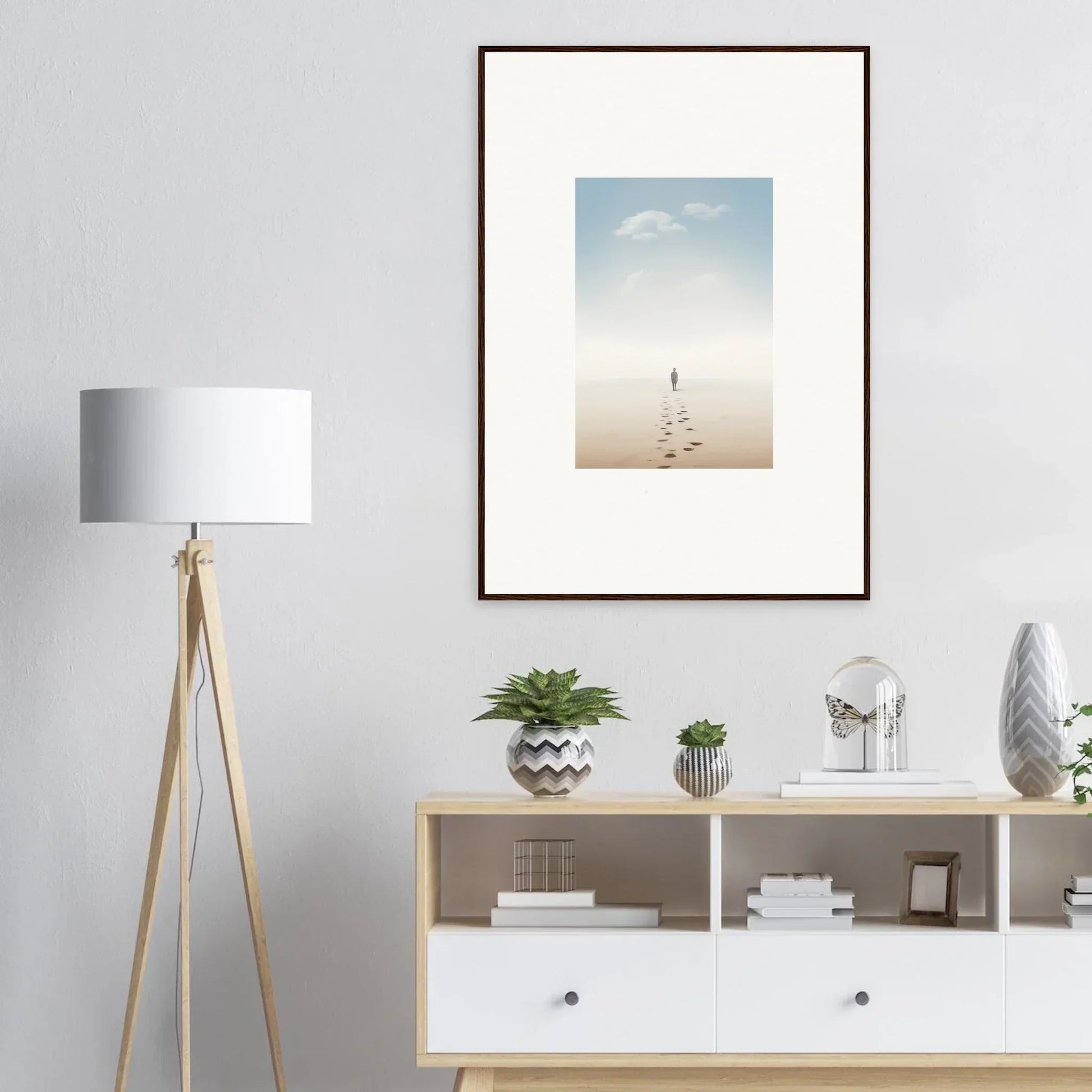 Framed wall art of a solitary figure on a beach evokes entwined nostalgia for room decor