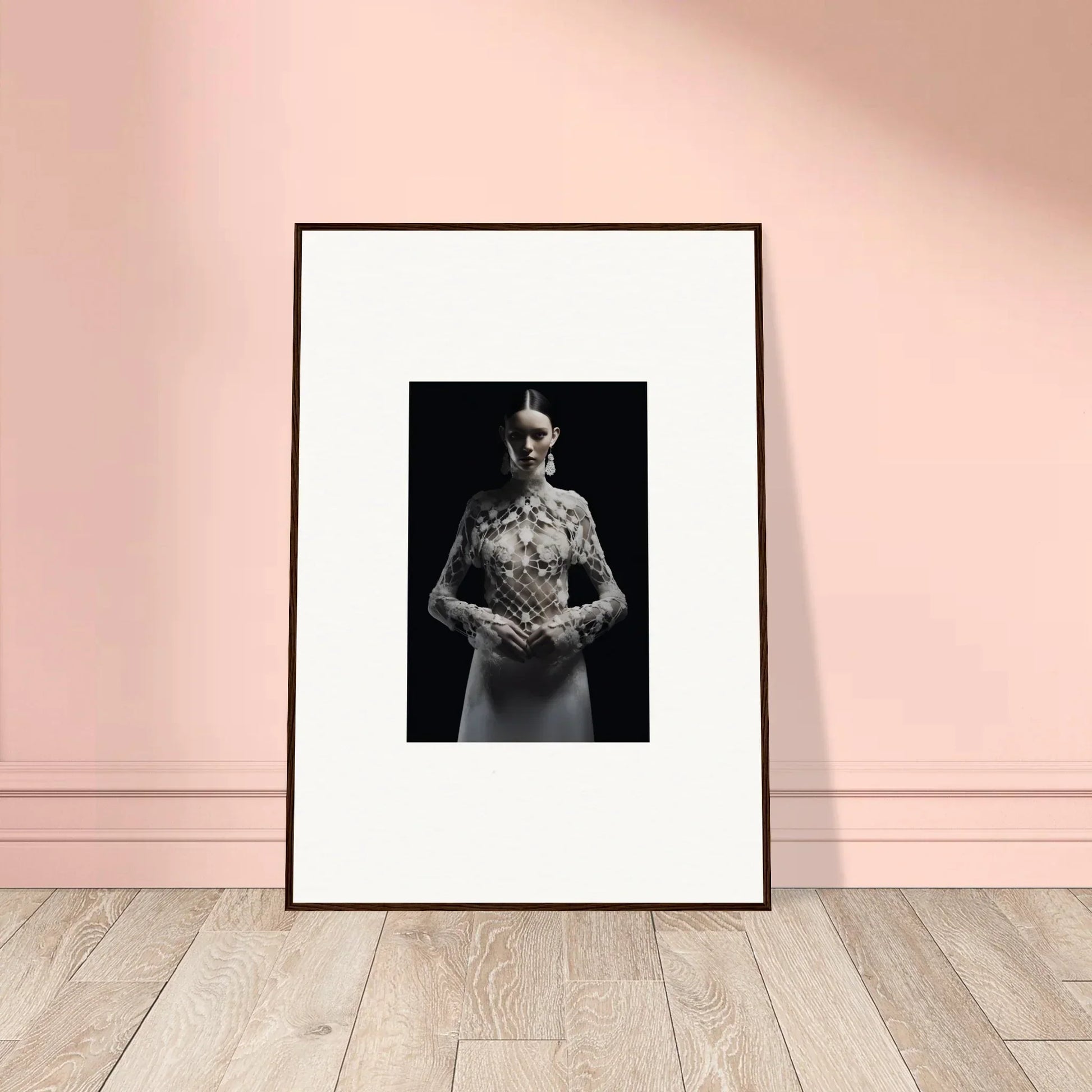 Framed black and white wall art of a person in an Etheris dress holding flowers