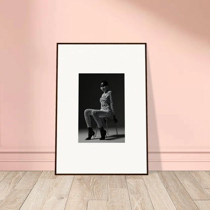 Framed black and white photograph of a person posing in a stylized outfit and boots.