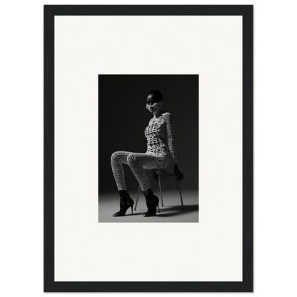 Black and white photograph of a woman seated on a stool wearing a patterned outfit and high heels.