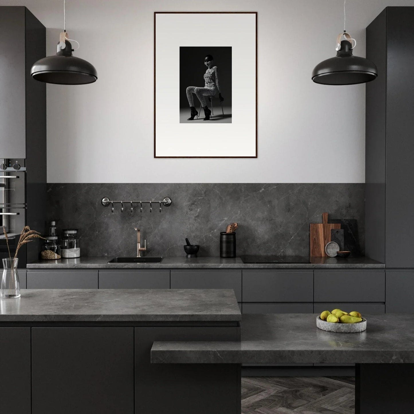 Modern kitchen with dark cabinetry, pendant lights, and a framed black-and-white photograph on the wall.