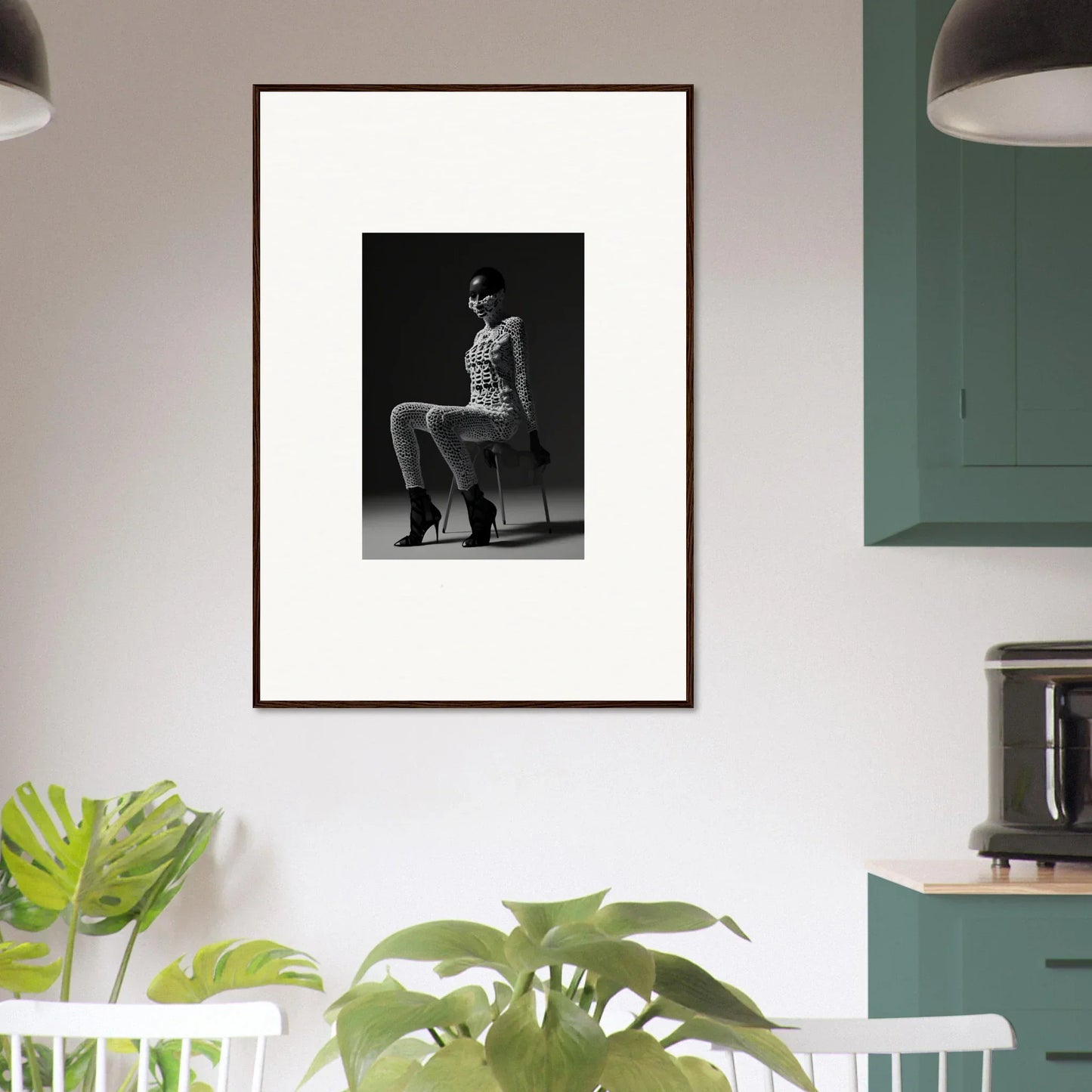 Framed black and white photograph of a person sitting on a chair.