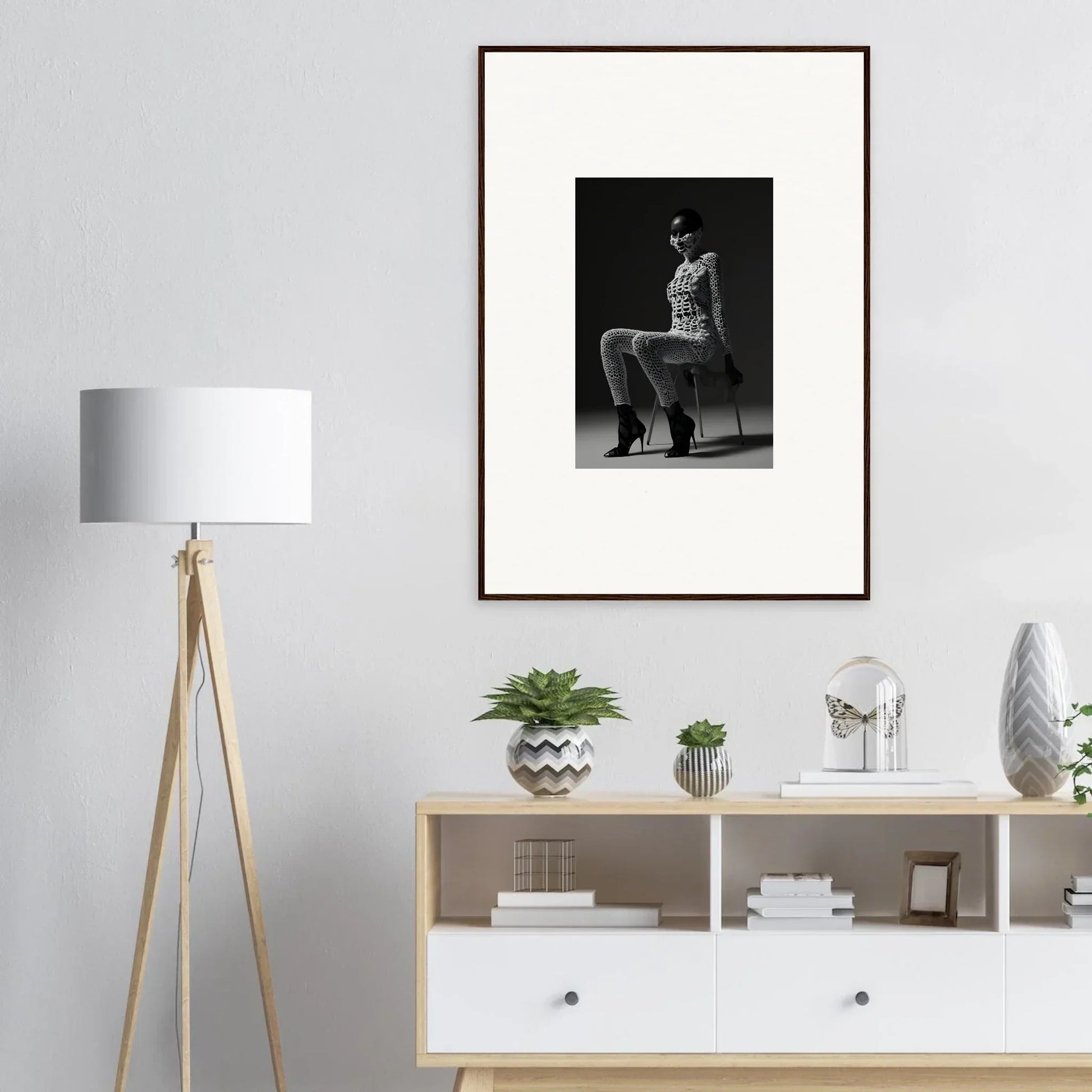 Framed black and white photograph of a person sitting on a chair.