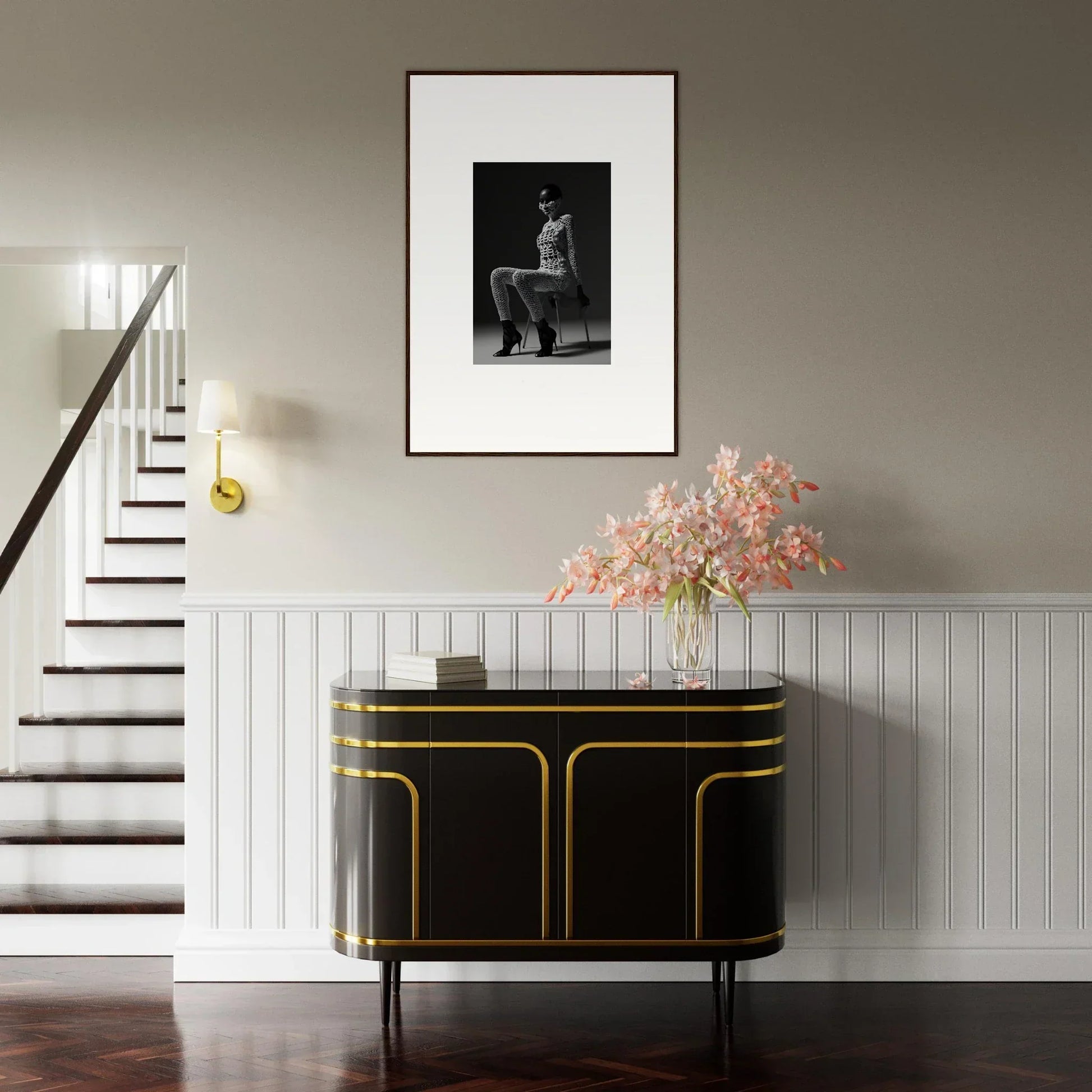 Elegant black and gold sideboard with curved edges beneath a framed artwork and floral arrangement.