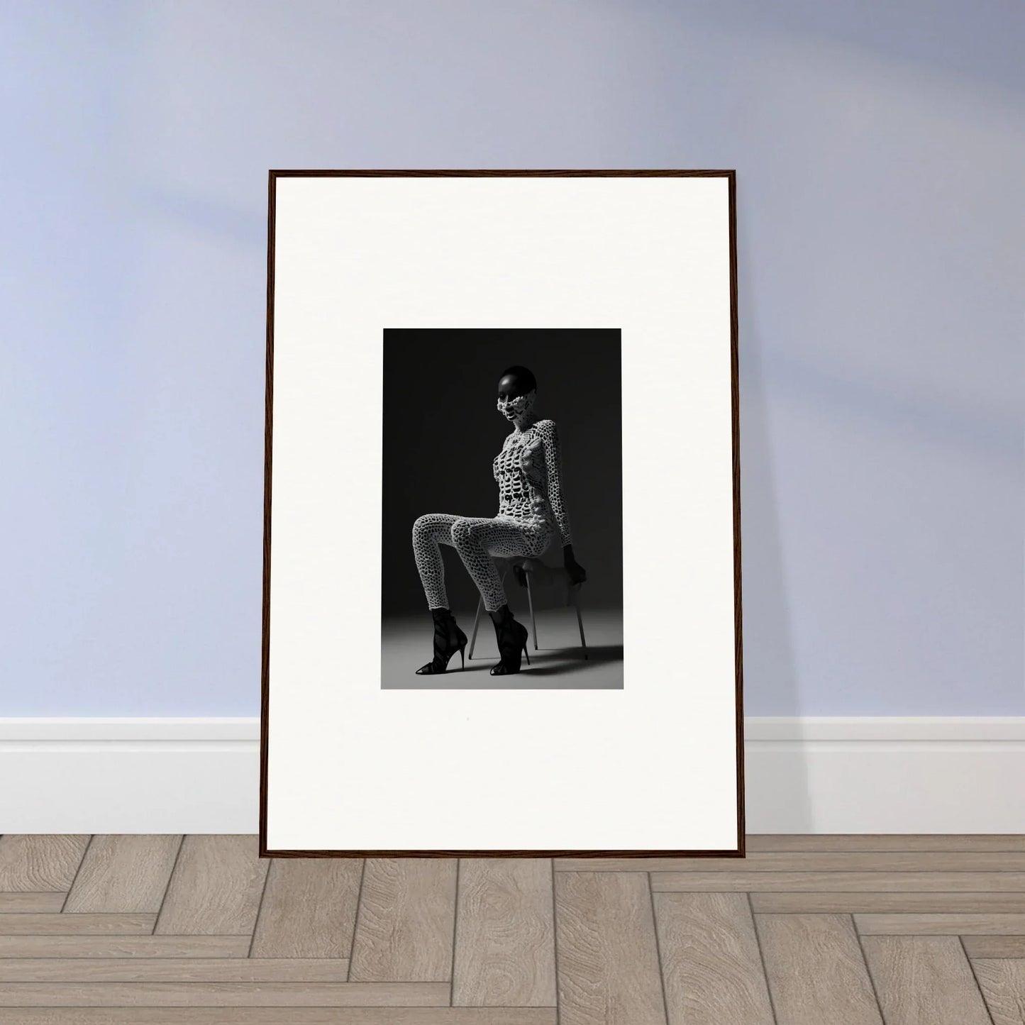 Framed black and white photograph of a person seated on a chair.