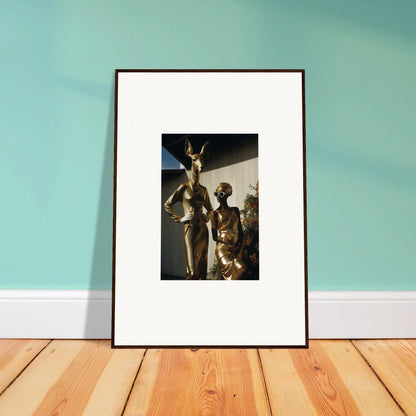 Framed photograph of bronze statues depicting human figures.