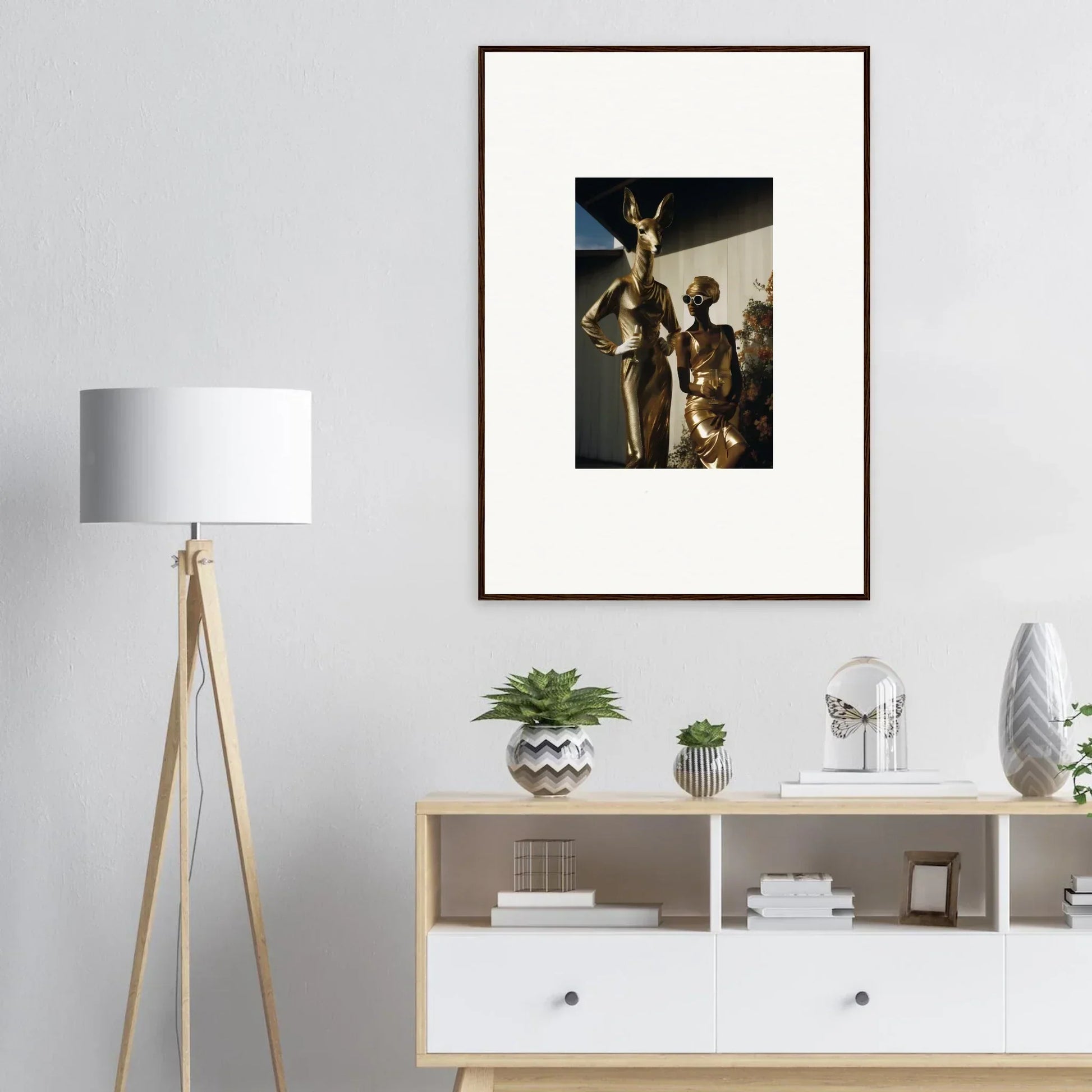 Framed photograph of ancient Egyptian statues displayed on a wall.